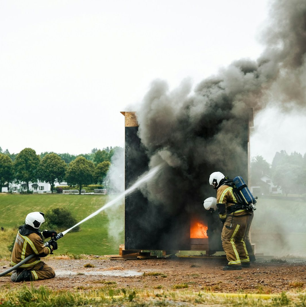 a couple of fire fighters are putting out a fire